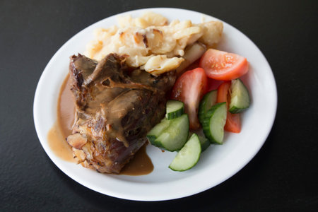 Plate with local lamb dish in Iceland, Potatoes, cucumber, tomatoes