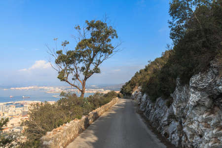 Road downhill on the edge of The Rock cliff, Gibraltar summer season day timeの写真素材