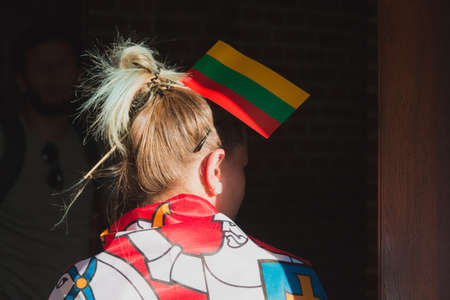 Young woman with sticked lithuanian flag in hairsの写真素材