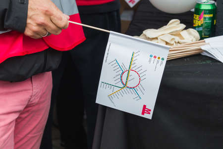 Copenhagen, Zealand Denmark - 29 9 2019: Man holding a flag with map of new M3, M4 Cityringen metro. New metro line opening dayのeditorial素材