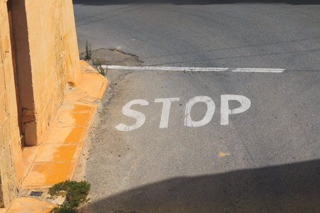 STOP Pavement Marking on street in Malta, Gozo island, Left-hand traffic