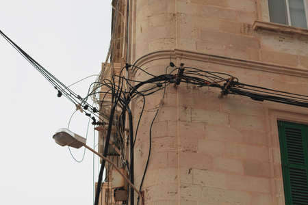 Messy electrical cables on buildings in Malta close up viewの写真素材