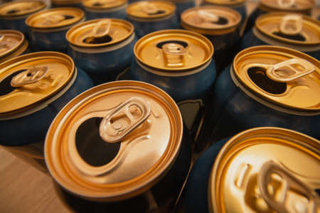 Open cans of beer standing on wooden floor. Wide angleの写真素材