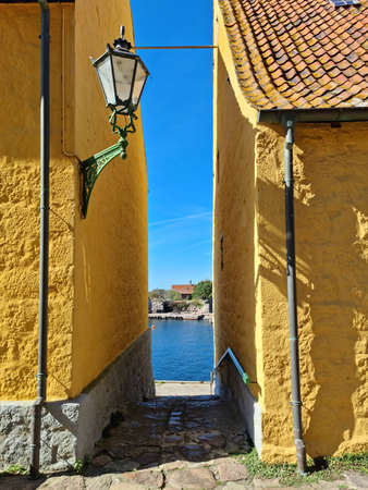 Old yellow buildings from 1789 in the small island of the Baltic seaの写真素材
