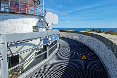 Two radio antennas transmitters and sign of Caution strong radio waves signの写真素材