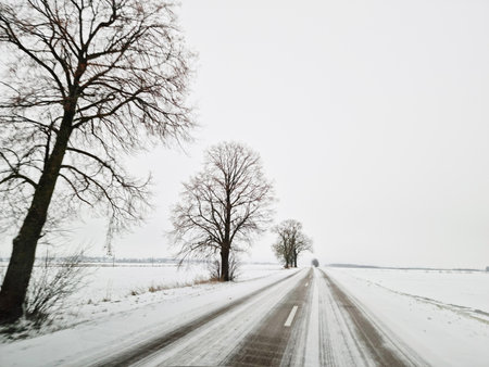 Drive on the snow-covered road. Slippery conditions. Lithuania Europe Point of viewの写真素材