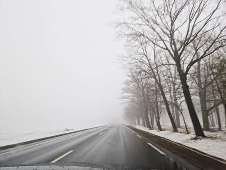 Drive on wet road in heavy fog mist. Lithuania Europe unionの写真素材