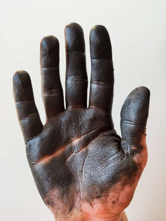 Caucasian Mechanic oily hand in white backgroundの写真素材
