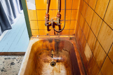 Rust stains in bathtub on wall and bath. High level Iron dissolved in a water. Ferrous Ironの写真素材