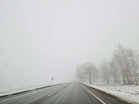 Drive on wet road in heavy fog mist. Lithuania Europe union.の写真素材