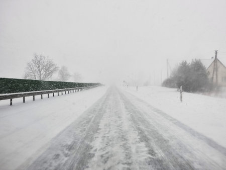 Drive in poor visibility conditions strong snow storm in Panevezys Region Lithuania - winter season poin of viewの写真素材