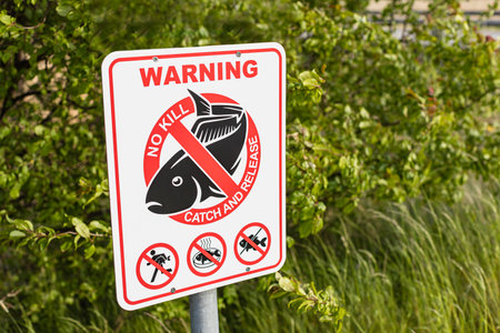 Sign to regulate fishing rules - Warning. No kill. Catch and release.の写真素材