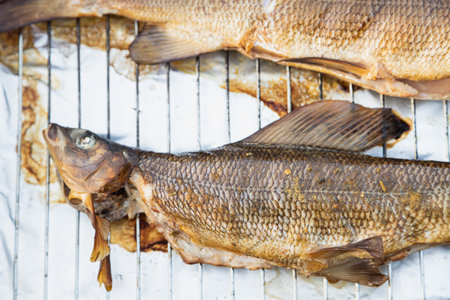 Smoking fish in the hot smoke machine - Norwayの写真素材
