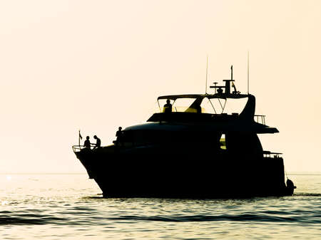 Motor boat is going to the harbor after a day on the Adriatic sea.の写真素材