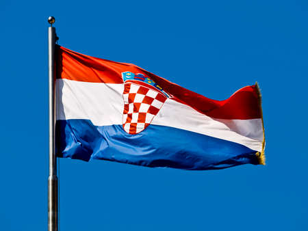 Croatian flag waving in the wind against blue sky.の写真素材