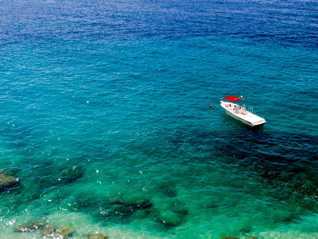 Alone boat on the clear blue adriatic sea.の写真素材