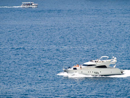 Tourist boat passing by on the clear blue adriatic sea.の写真素材
