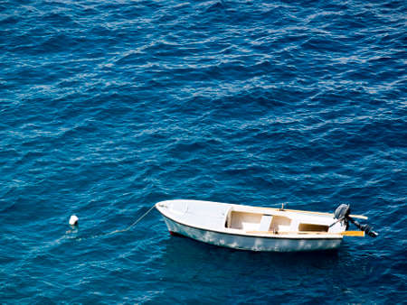 Alone boat on the clear blue adriatic sea.の写真素材