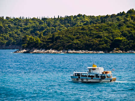 Tourist boat passing by near the adriatic coast.の写真素材