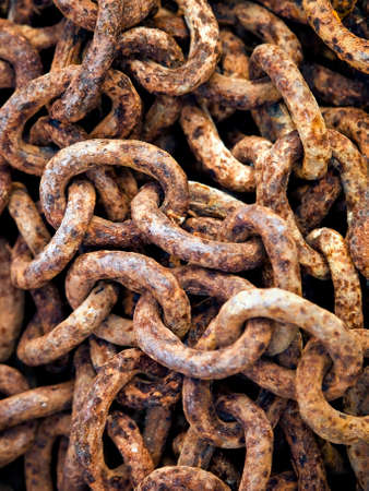Just a rusty metal chain on the ground. Focus in the middle.の写真素材