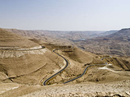 Canyon landscape  in Jordan with road going down. Hill-side slope also going down in perspective (that is why horizon is not horizontal)の写真素材