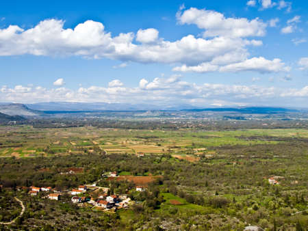 Mediterranean landscape with clouds and small villageの写真素材