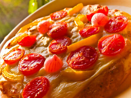 Vegetarian Pizza close up with tomato and onion detailの写真素材