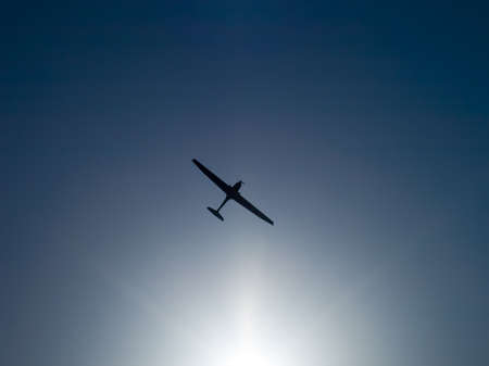 Airplane silhouette on spring sunny dayの写真素材