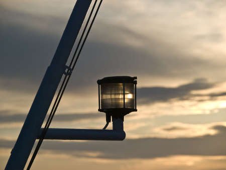 Signal lamp on the ship against clouds at sunset.の写真素材