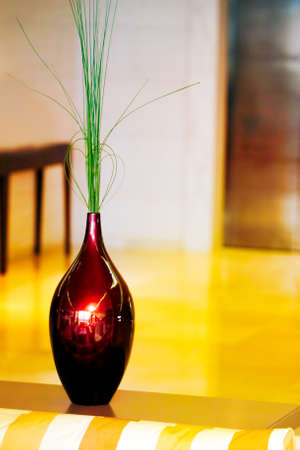 Decoration red reflection vase against yellow backgroundの写真素材