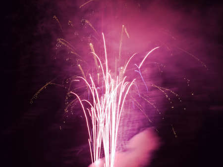 Fireworks rockets exploding against dark sky.の写真素材