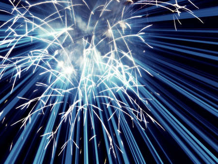 Digitally enhanced firework.  Blue rockets with light rays in background.の写真素材