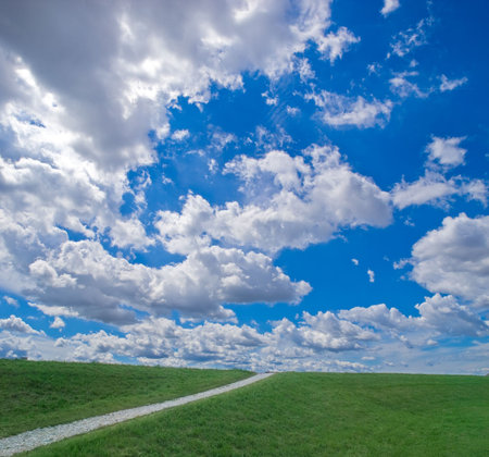 Path to the blue sky with clouds.