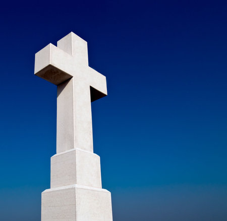 Big stone cross against a blue sky. Copy space on the right. Vukovar, Croatia location