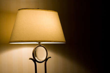 Lamp casting light in a dark room.の写真素材