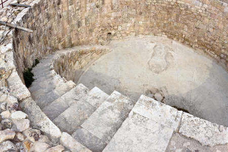 Water cistern. Roman time citadel in Amman, capital of Jordan. Detail with stairs. Fish eye lens shot.の写真素材