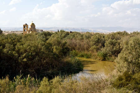 River Jordan and church on the baptism site in Bethany, Jordan. Place where Jesus was baptized.の写真素材