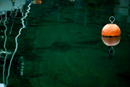 Orange buoy in a marine with copy space around itの写真素材