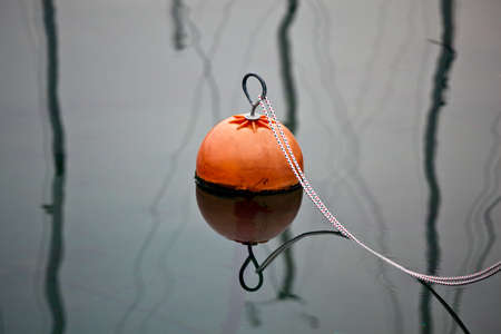 Orange buoy in a marine with copy space around itの写真素材