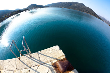 Ladder for swimmers in small village Hodilje near Ston on Peljesac peninsula, Croatia, Europe. Fish...