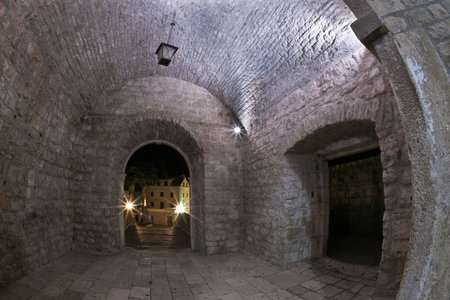 Main entrance to the old medieval town Korcula  by night. Croatia,  Dalmatia region, Europe. Fish eye lens shot.の写真素材