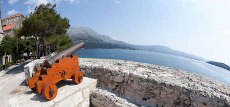 Cannon at old fortress in medieval town Korcula. Croatia, Dalmatia region, Europe.の写真素材