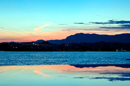 Split panorama at sunset.  Sky reflection on the water surface.の写真素材