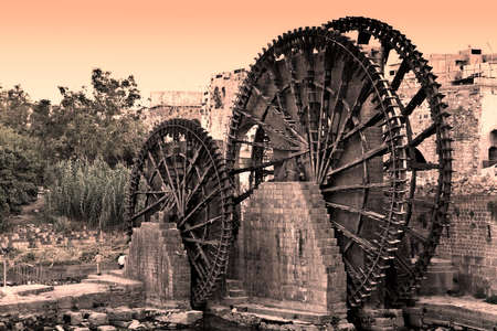 Hama (ancient Hamath). Part of 17 ancient wooden norias (1100 BC) on Orontes River used for watering the gardensの写真素材
