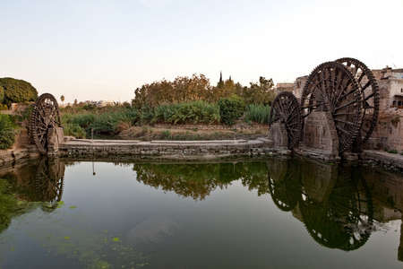 Hama (ancient Hamath). Part of 17 ancient wooden norias (1100 BC) on Orontes River used for watering the gardensの写真素材