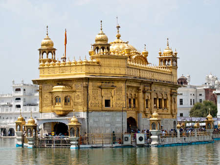 Golden Temple. Holiest shrine of the Sikh religion. Ornate gold covered building in the middle of an artificial lake in Amritsar, Punjab, India.の写真素材