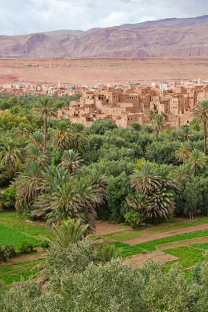 Panorama of a village in Moroccan hills, Morocco, thousand Kasbah road. Oasis in Sahara desert area. Plantation of palm trees.の写真素材