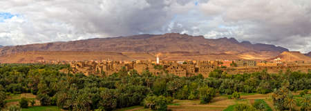 Panorama of a village in Moroccan hills, Morocco, thousand Kasbah road. Oasis in Sahara desert areaの写真素材