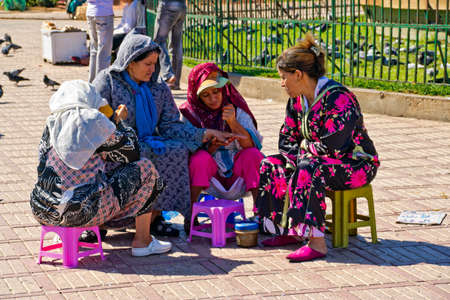 CASABLANCA, MOROCCO - OCTOBER, 16, 2010: Women on main square in Casablanca putting henna on a hands. Henna has been used to adorn young women's bodies as part of social and holiday celebrationsのeditorial素材