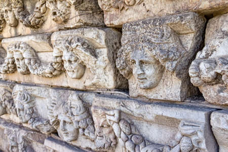 Building relief detail of architectural frieze with human head in Aphrodisias (Turkey) build during Roman period.の写真素材